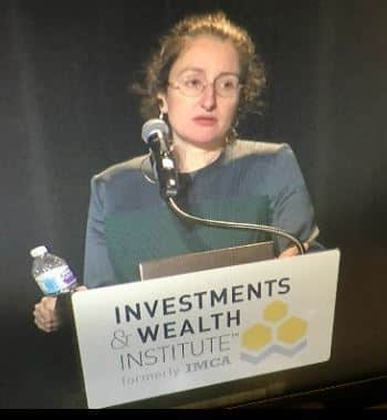 Sara Grillo is shown speaking at the investment & Wealth financial advisor conference a few years back.